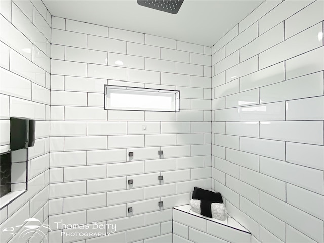 bathroom with tiled shower