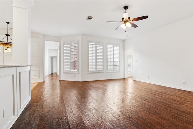 unfurnished living room featuring dark hardwood / wood-style flooring and ceiling fan