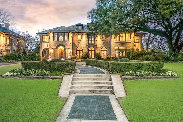 view of front of home with a lawn