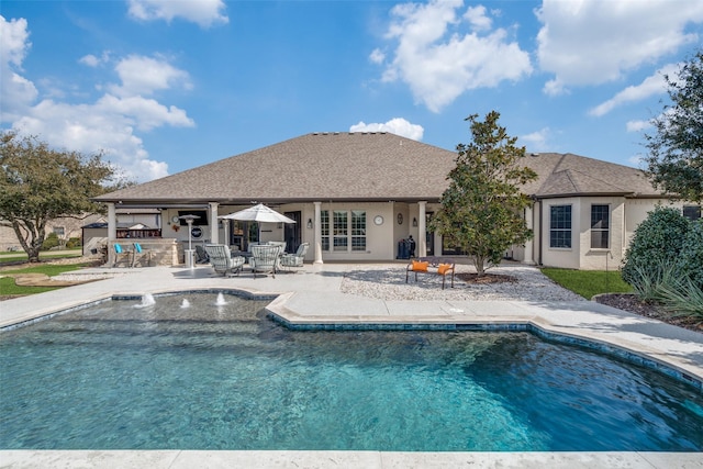 view of swimming pool featuring an outdoor bar and a patio area