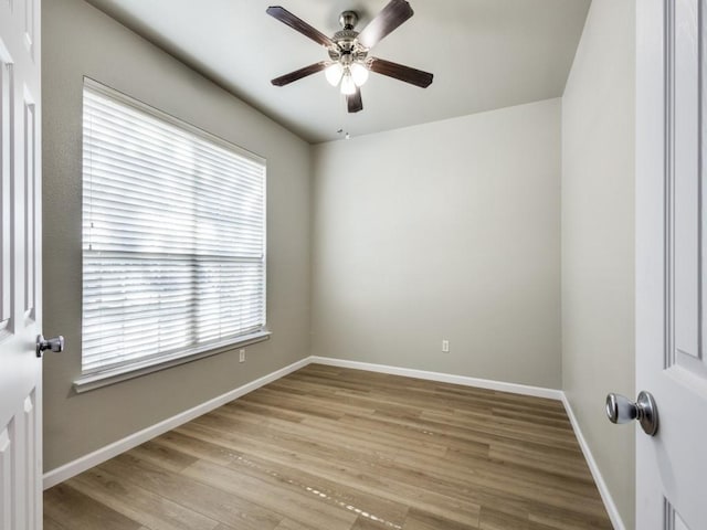 spare room with ceiling fan and light wood-type flooring