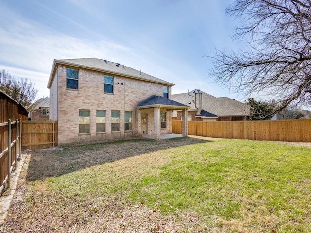 back of house featuring a lawn