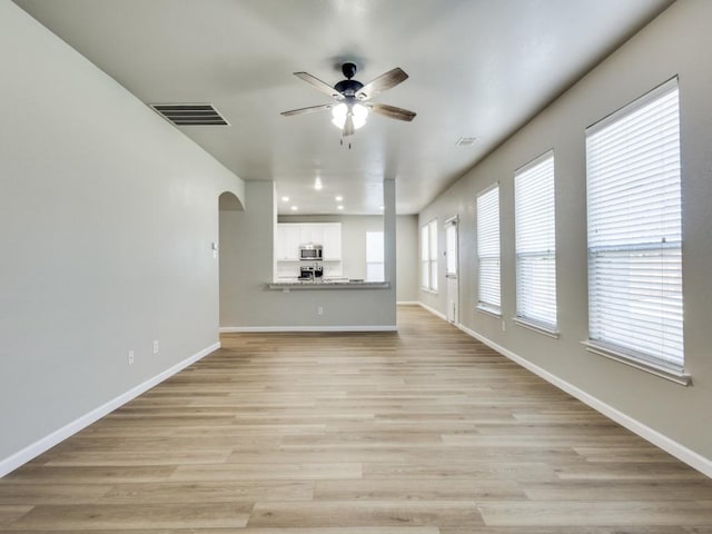 unfurnished living room with ceiling fan and light hardwood / wood-style floors