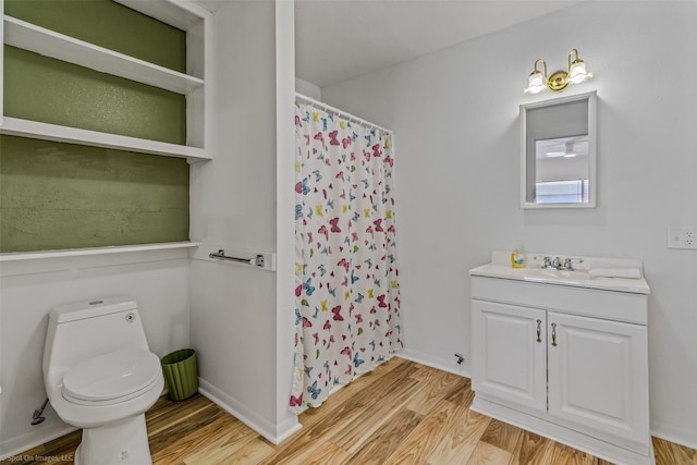 bathroom featuring hardwood / wood-style flooring, vanity, toilet, and a shower with shower curtain