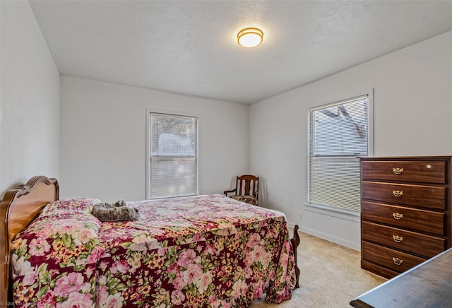 carpeted bedroom featuring a textured ceiling