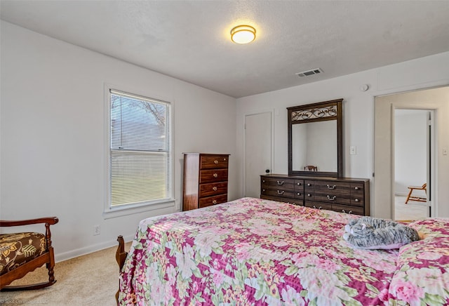 carpeted bedroom featuring a textured ceiling