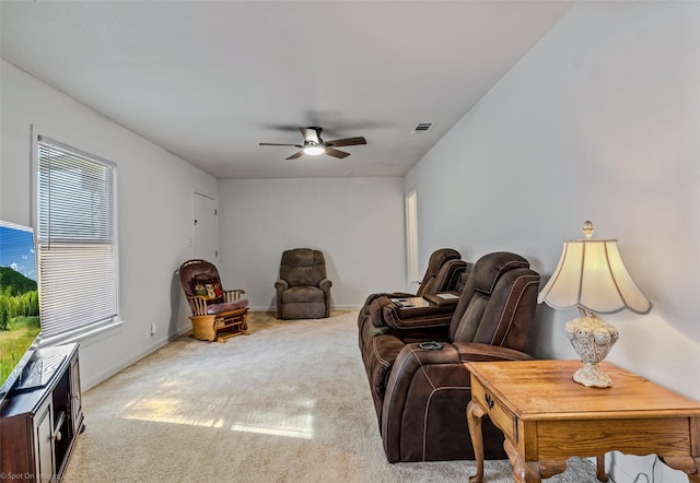 living room featuring ceiling fan and carpet flooring