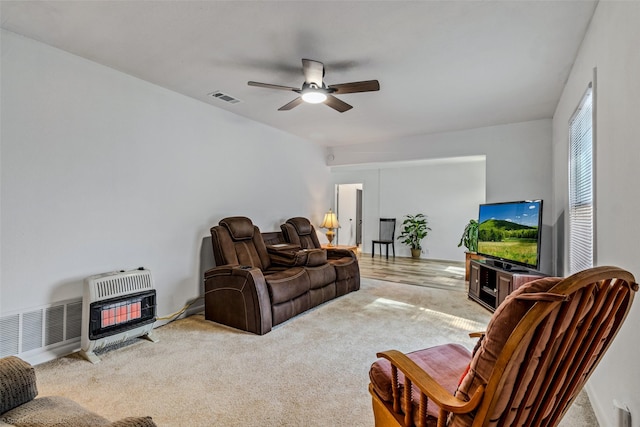 carpeted living room featuring ceiling fan and heating unit