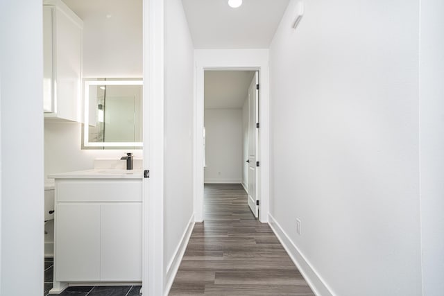 hallway with dark hardwood / wood-style flooring and sink