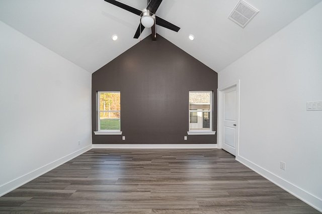 empty room with ceiling fan, dark wood-type flooring, high vaulted ceiling, and a healthy amount of sunlight