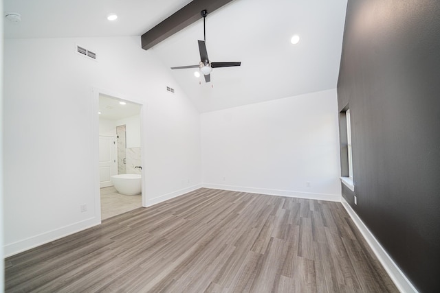 unfurnished bedroom featuring ceiling fan, high vaulted ceiling, connected bathroom, beamed ceiling, and light wood-type flooring