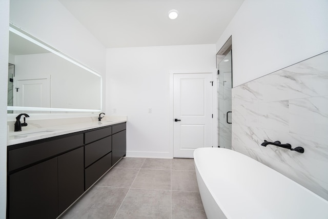 bathroom featuring tile patterned floors, vanity, plus walk in shower, and tile walls