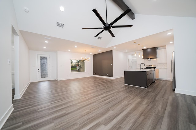 living room featuring sink, dark wood-type flooring, beam ceiling, high vaulted ceiling, and ceiling fan with notable chandelier