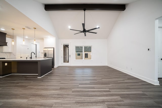 kitchen with sink, hanging light fixtures, beam ceiling, stainless steel refrigerator with ice dispenser, and dark hardwood / wood-style flooring