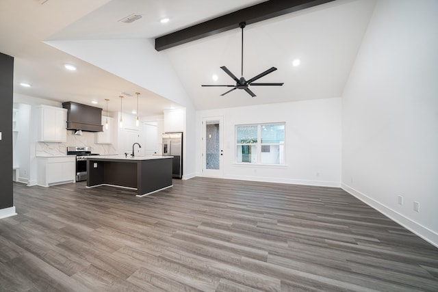 kitchen featuring hanging light fixtures, a center island with sink, custom range hood, stainless steel appliances, and white cabinets