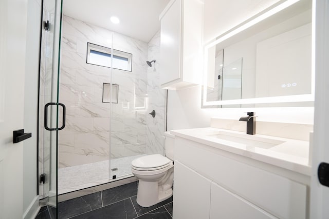 bathroom with vanity, toilet, and walk in shower