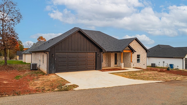 view of front of home featuring a garage and cooling unit