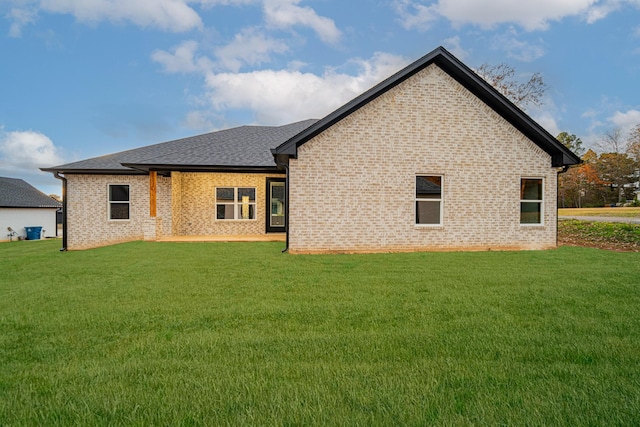 rear view of property featuring a lawn