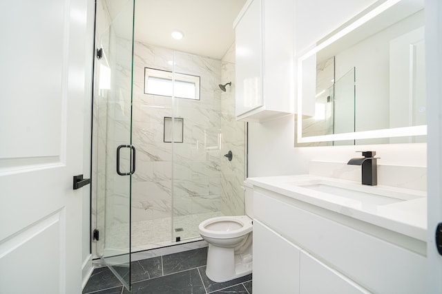 bathroom with vanity, toilet, and a shower with shower door