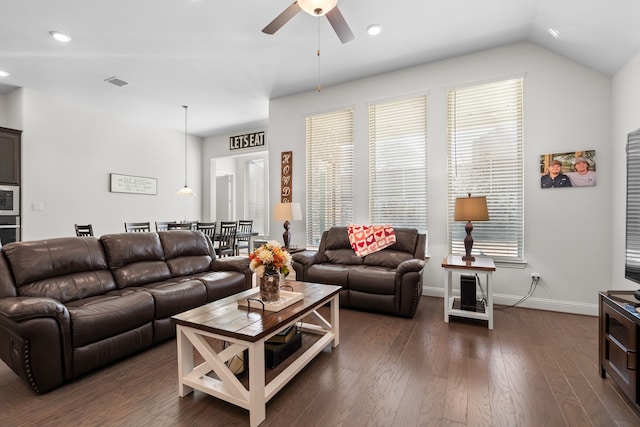 living room featuring lofted ceiling, dark wood-type flooring, and ceiling fan