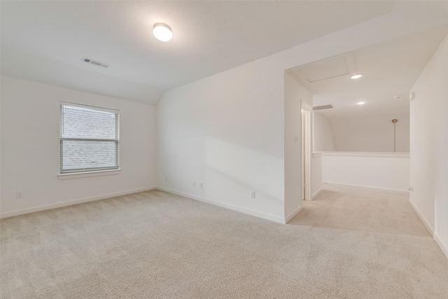 carpeted spare room featuring lofted ceiling