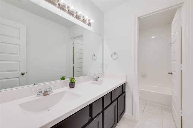 bathroom featuring tile patterned flooring, vanity, and tiled shower / bath