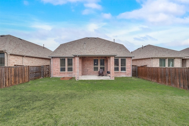 rear view of property featuring a yard and a patio