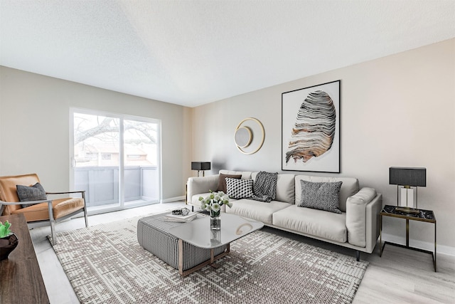 living room featuring light hardwood / wood-style floors and a textured ceiling