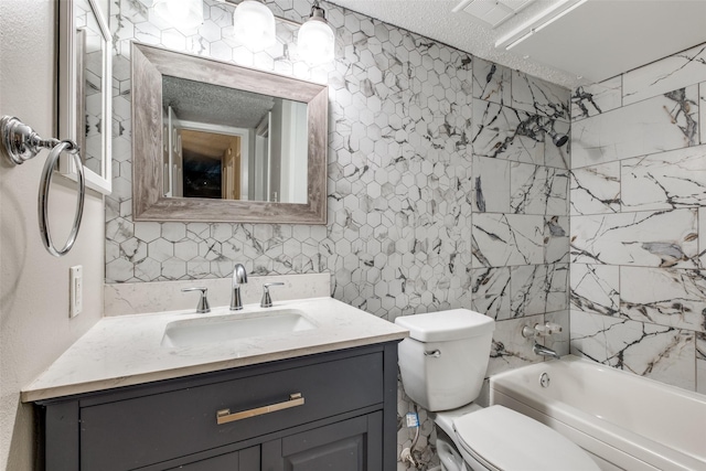 full bathroom with vanity, tiled shower / bath, a textured ceiling, and toilet