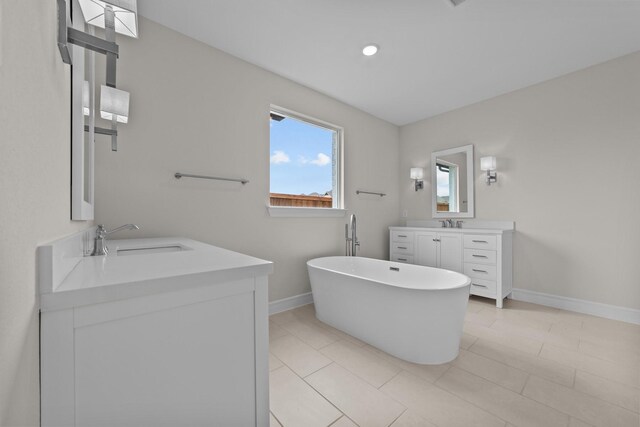 11529 Wulstone Rd, Fort Worth, TX 76052 - full bathroom with baseboards, two vanities, and a freestanding bath