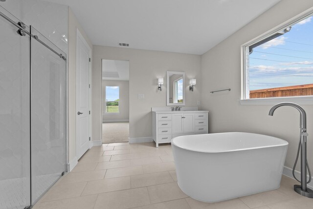 11529 Wulstone Rd, Fort Worth, TX 76052 - bathroom featuring vanity, a shower stall, a freestanding bath, and tile patterned floors