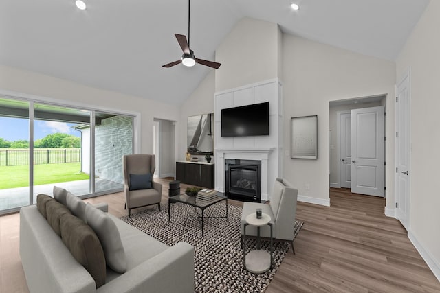 11529 Wulstone Rd, Fort Worth, TX 76052 - living room with high vaulted ceiling, a ceiling fan, a glass covered fireplace, baseboards, and wood finished floors
