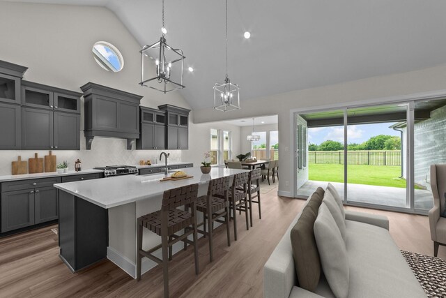 11529 Wulstone Rd, Fort Worth, TX 76052 - kitchen with a chandelier, high vaulted ceiling, open floor plan, a kitchen breakfast bar, and gray cabinets