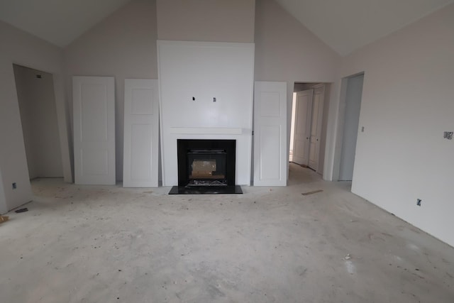 unfurnished living room featuring high vaulted ceiling