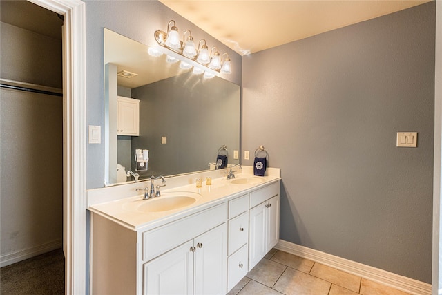 19482 Ruggles Ct, Flint, TX 75762 - bathroom featuring double vanity, baseboards, and tile patterned floors