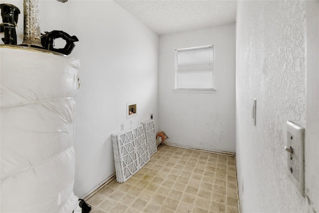 laundry area featuring hookup for a washing machine and a textured ceiling