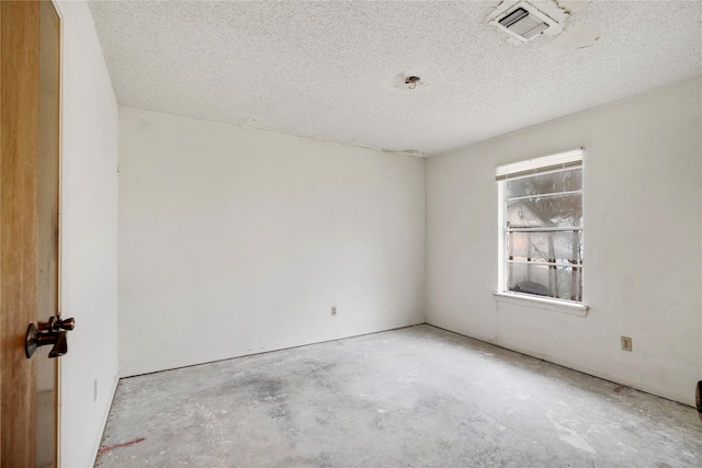 empty room with a textured ceiling