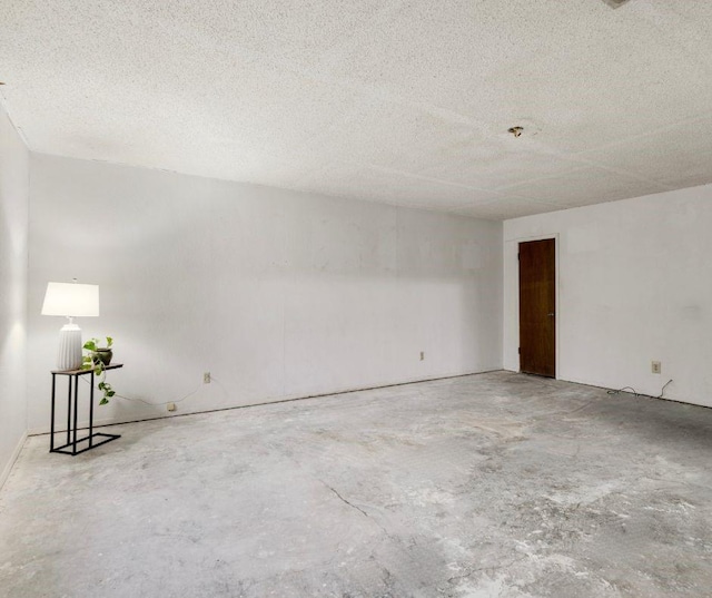 spare room featuring concrete floors and a textured ceiling