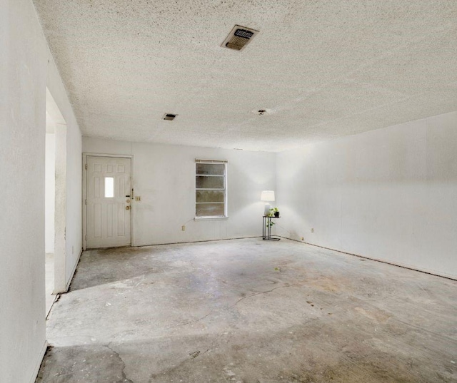 empty room with a textured ceiling