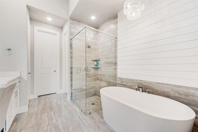 1845 Leo Dr, Van Alstyne, TX 75495 - bathroom featuring a freestanding tub, a stall shower, vanity, recessed lighting, and marble finish flooring