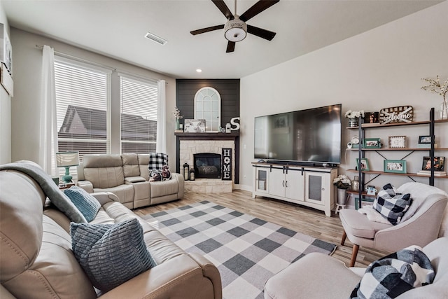 1845 Leo Dr, Van Alstyne, TX 75495 - living room with a ceiling fan, light wood-style flooring, healthy amount of natural light, a stone fireplace, and recessed lighting