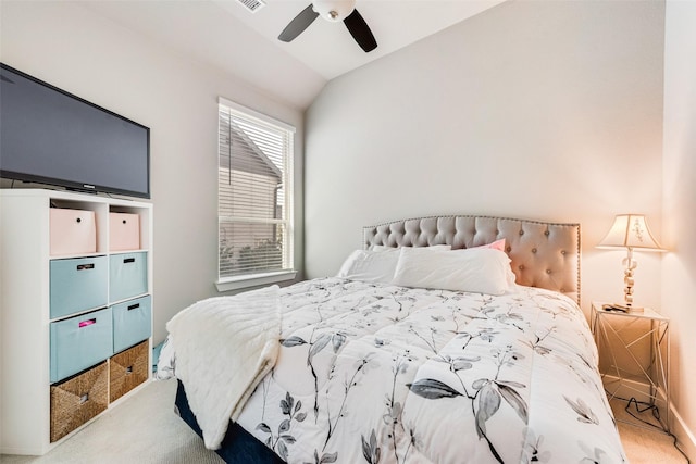 carpeted bedroom featuring vaulted ceiling, ceiling fan, and visible vents