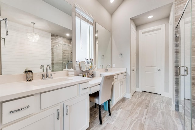 full bathroom featuring a sink, two vanities, a shower stall, and recessed lighting