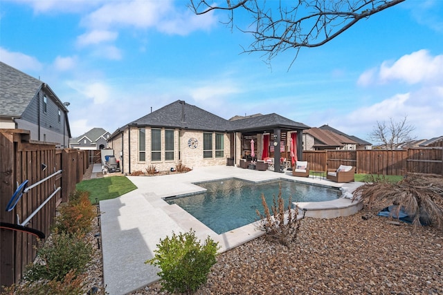 rear view of house featuring a fenced in pool, brick siding, a patio, roof with shingles, and a fenced backyard