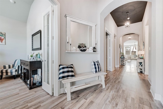1845 Leo Dr, Van Alstyne, TX 75495 - corridor with arched walkways, light wood-style floors, and baseboards