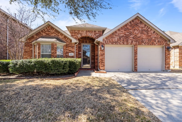 view of front of property with concrete driveway, brick siding, and an attached garage