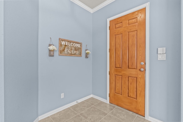 entrance foyer featuring ornamental molding, baseboards, and light tile patterned floors