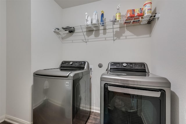 laundry room featuring wood-type flooring and washing machine and dryer