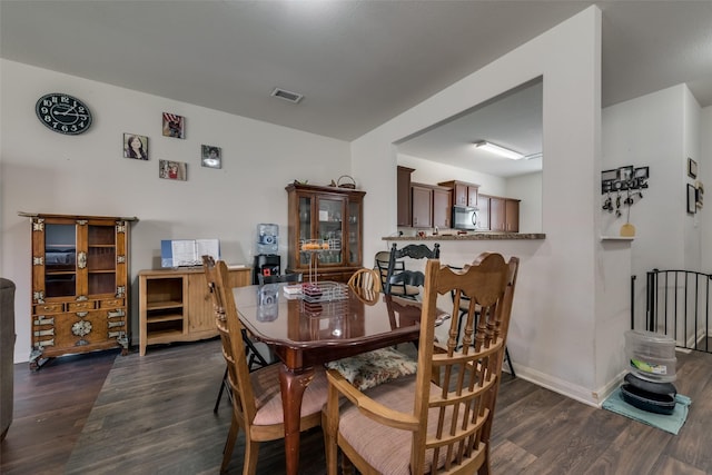 dining room with dark hardwood / wood-style flooring