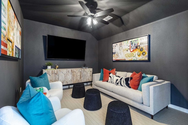 cinema with vaulted ceiling, ceiling fan, and carpet flooring